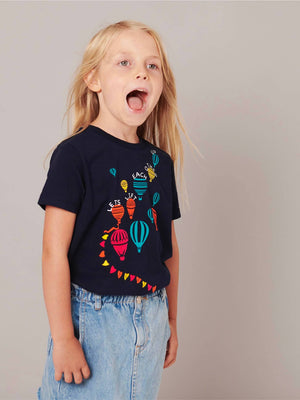 A small child wearing a unisex t-shirt with hot air ballons by The Faraway Gang.