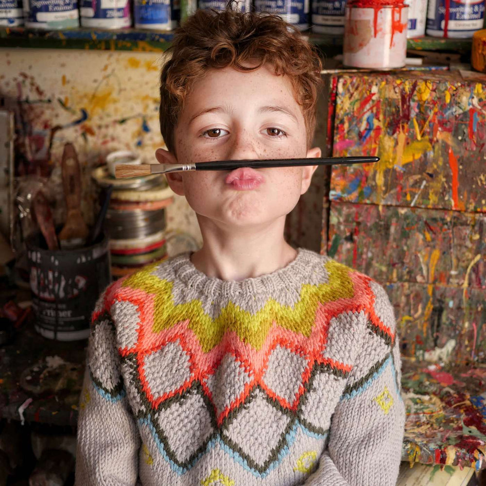 Child wearing a hand-knit jumper by The Faraway Gang.