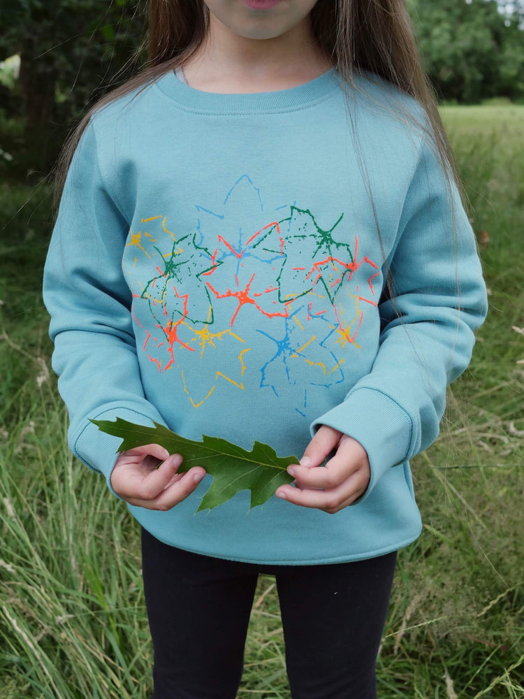 
            
                Load image into Gallery viewer, Girl wearing The &amp;#39;Rambler&amp;#39; Children&amp;#39;s Printed Sweatshirt holding a leaf.
            
        