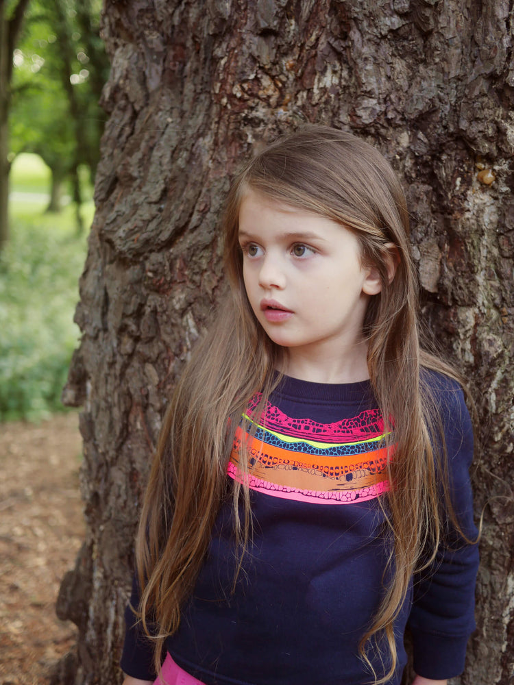 Girl leaning against a tree The 'Creator' Children's Printed Sweatshirt.