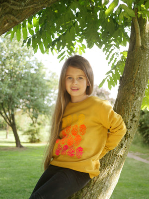 Girl sitting in a tree wearing The 'Forager' Sweatshirt.