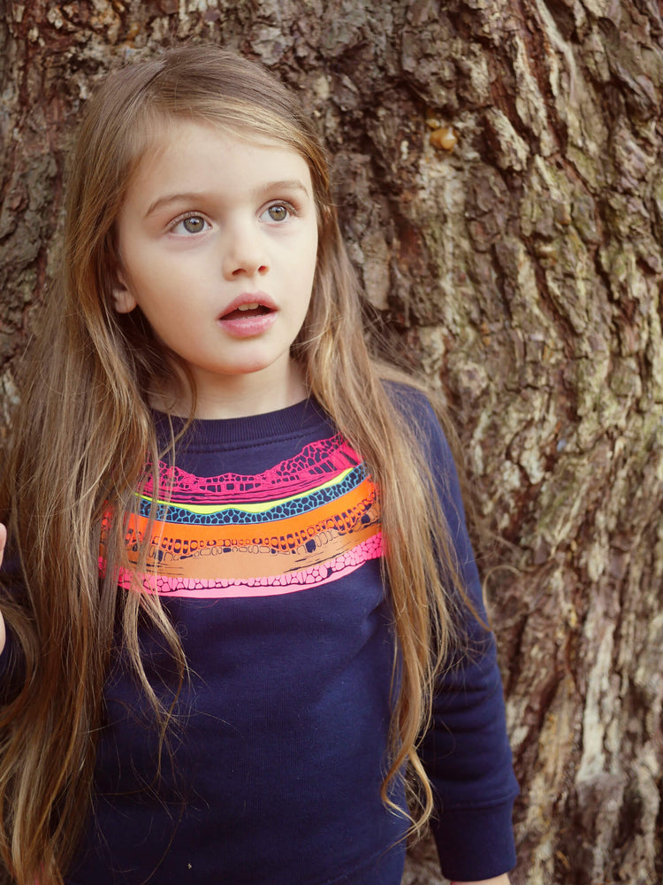 Girl leaning against a tree The 'Creator' Children's Printed Sweatshirt.