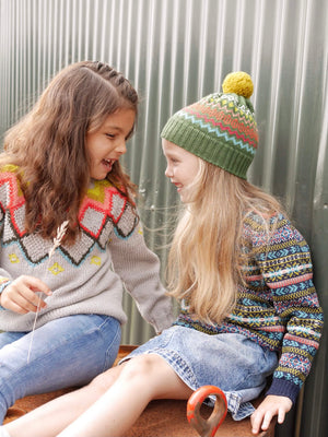 Two young girls chatting wearing The Faraway Gang knitwear.