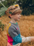 A young boy wearing The Faraway Gang's 'Stargazer' Knitted Jumper wearing a cardboard crown.