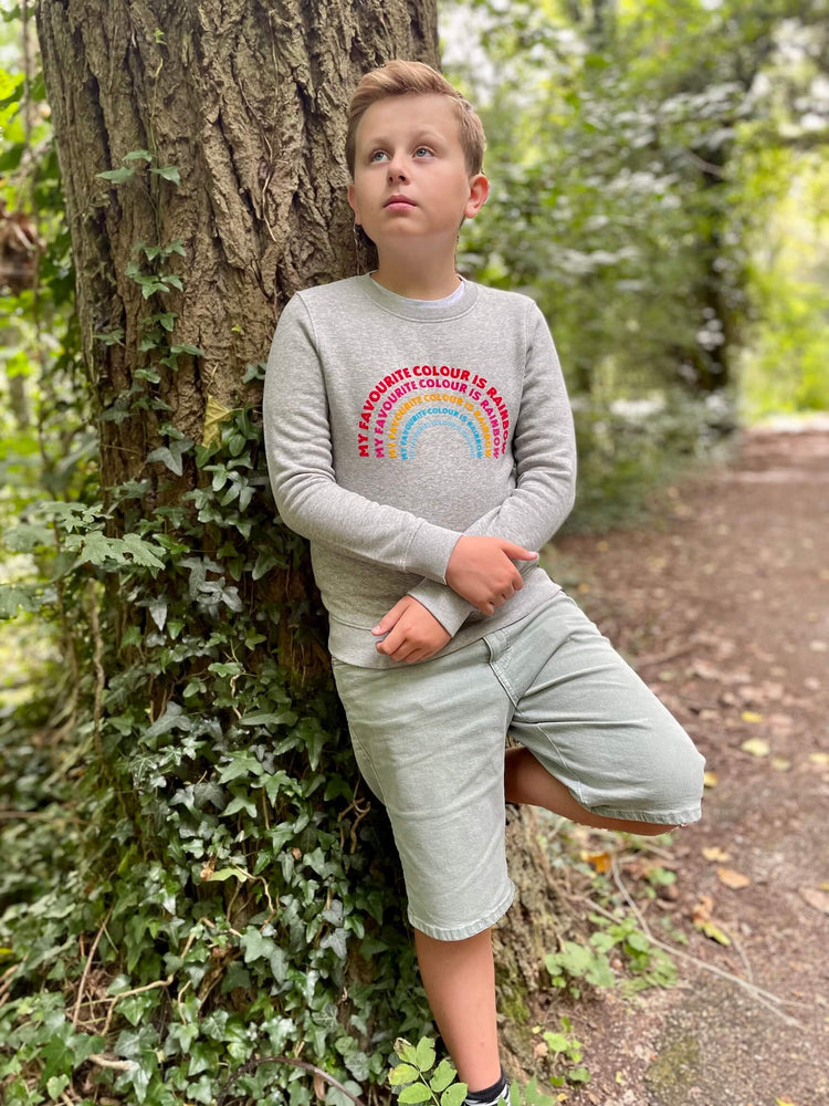 a 'Rainbow' Sweatshirt by The Faraway Gang with a rainbow on it.