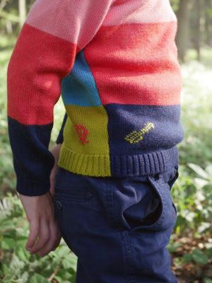A close up of the details on a 'The Stargazer' Knitted Jumper by The Faraway Gang worn by a little boy.  